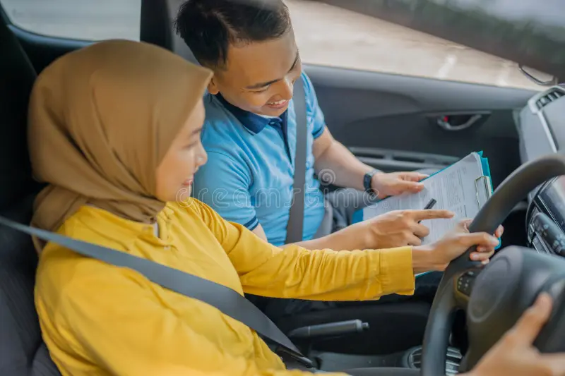 Learner driver practicing safety techniques with instructor